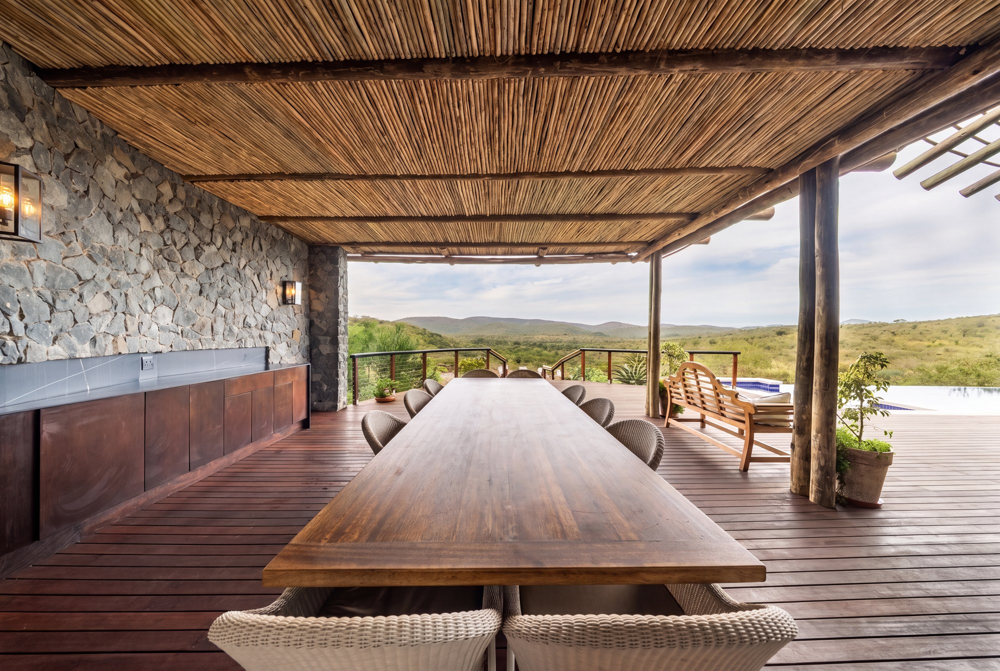 Shaded long-table dining on the deck above the reserve